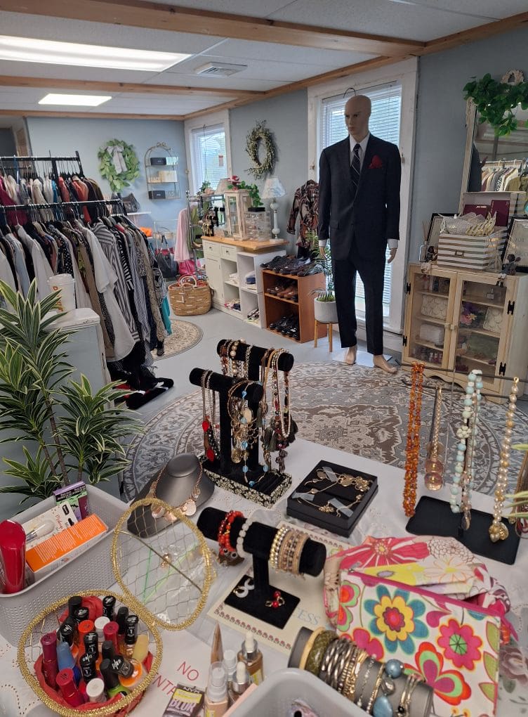Boutique interior with clothing and jewelry displayed.