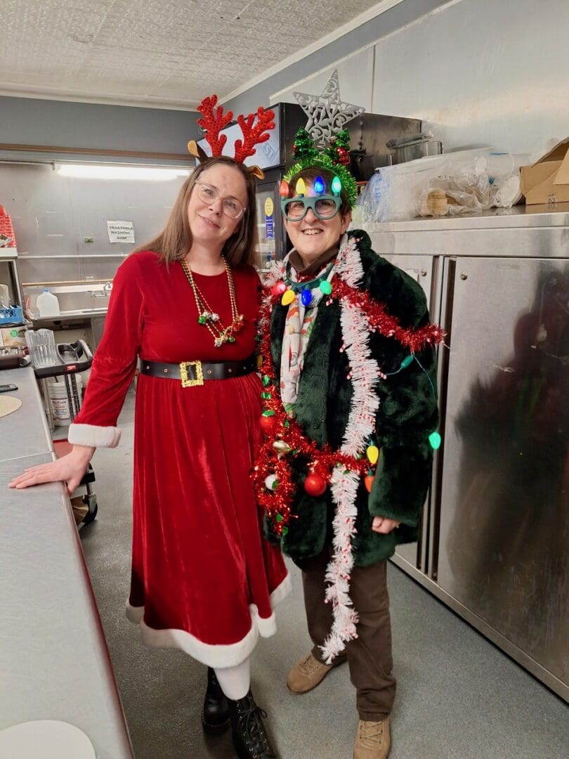 Two people in festive Christmas costumes